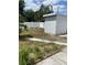 View of the backyard with a small storage shed, privacy fence, and sparse lawn at 5562 Old Tampa Hwy, Davenport, FL 33896