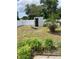 View of the backyard with a small storage shed, privacy fence, and sparse lawn at 5562 Old Tampa Hwy, Davenport, FL 33896