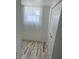 Bright bedroom featuring plank flooring, white walls, a window with sheer curtains and a closet at 5562 Old Tampa Hwy, Davenport, FL 33896