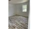 Bright bedroom featuring charming plank flooring, white walls and ample natural light from the window at 5562 Old Tampa Hwy, Davenport, FL 33896