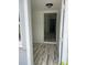 Inviting foyer with stylish plank flooring, opening to a bright interior with a view to the kitchen at 5562 Old Tampa Hwy, Davenport, FL 33896