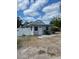 Charming single-story home with a light gray exterior, a well-kept front yard, and a white fence at 5562 Old Tampa Hwy, Davenport, FL 33896