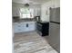 Bright kitchen with stainless steel appliances and white cabinets offers modern convenience at 5562 Old Tampa Hwy, Davenport, FL 33896