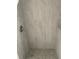 Modern shower featuring gray tiling, updated fixtures and stylish accents, adding a touch of elegance at 5562 Old Tampa Hwy, Davenport, FL 33896
