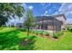 Spacious backyard featuring a screened-in pool area, perfect for outdoor relaxation and entertainment at 6086 Broad Oak Dr, Davenport, FL 33837