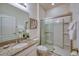 Clean bathroom featuring a granite vanity top, glass shower, and neutral decor at 6086 Broad Oak Dr, Davenport, FL 33837
