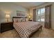 Bedroom featuring plush carpet, an art piece, and natural lighting at 6086 Broad Oak Dr, Davenport, FL 33837