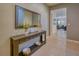 Inviting entryway featuring stylish console table, decorative mirror, and easy access to the living areas at 6086 Broad Oak Dr, Davenport, FL 33837
