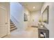 Welcoming entryway with staircase, neutral decor, and tile flooring at 6086 Broad Oak Dr, Davenport, FL 33837