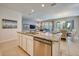Bright, open kitchen with a granite island and stainless steel appliances at 6086 Broad Oak Dr, Davenport, FL 33837
