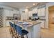 Modern kitchen with white cabinets, granite countertops, stainless steel appliances, and a breakfast bar at 6086 Broad Oak Dr, Davenport, FL 33837