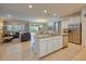 Open concept kitchen with granite island, stainless appliances, and seamless flow to the living area at 6086 Broad Oak Dr, Davenport, FL 33837