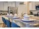 Elegant kitchen island featuring granite countertops, seating, and modern fixtures at 6086 Broad Oak Dr, Davenport, FL 33837
