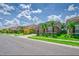Charming street view of modern homes with well-manicured lawns and tropical landscaping on a sunny day at 6086 Broad Oak Dr, Davenport, FL 33837