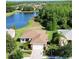 Aerial view of a home with landscaped front yard near community pond at 650 Portofino Drive, Poinciana, FL 34759