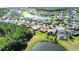 Aerial view of a community showcasing the home's fenced backyard and neighborhood pond at 650 Portofino Drive, Poinciana, FL 34759