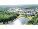 Bird's eye view of the neighborhood featuring the community's ponds, lush trees, and homes at 650 Portofino Drive, Poinciana, FL 34759