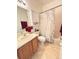Well-lit bathroom featuring a tile floor, updated vanity, and shower-tub combination at 650 Portofino Drive, Poinciana, FL 34759