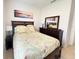 Bedroom featuring light neutral colors, large window and queen bed with an en-suite bathroom at 650 Portofino Drive, Poinciana, FL 34759