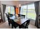 Bright dining room with modern chandelier, outdoor views, and seating for six at 650 Portofino Drive, Poinciana, FL 34759