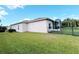 View of home's exterior showcasing its screened lanai, black metal fence, and well-maintained backyard at 650 Portofino Drive, Poinciana, FL 34759