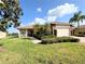 Charming single-story home with a well-manicured lawn, stone accents, and a two-car garage at 650 Portofino Drive, Poinciana, FL 34759