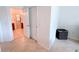 Hallway leading to an en-suite bathroom with tiled floors and linen closet at 650 Portofino Drive, Poinciana, FL 34759