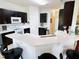 Modern kitchen with sleek countertops, dark cabinetry, and a convenient breakfast bar at 650 Portofino Drive, Poinciana, FL 34759