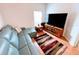 Comfortable living room with blue sectional sofa, large television, and a colorful area rug at 650 Portofino Drive, Poinciana, FL 34759