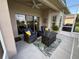 Relax on the screened patio with comfortable wicker furniture and an outdoor gas fire table at 650 Portofino Drive, Poinciana, FL 34759