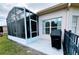 Outdoor patio with grill, adjacent to the screened lanai, offering space for grilling and outdoor dining at 650 Portofino Drive, Poinciana, FL 34759