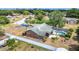 Aerial view of brick home with screened pool enclosure, fenced in backyard and green roof at 724 Knob Hill Cir, Kissimmee, FL 34744