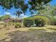 Backyard view of lovely brick home with screened pool enclosure and attractive landscaping at 724 Knob Hill Cir, Kissimmee, FL 34744