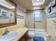 Bathroom featuring a tile countertop vanity and glass enclosed shower/tub combination at 724 Knob Hill Cir, Kissimmee, FL 34744