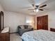 Bright bedroom featuring a comfy love seat, ceiling fan, and natural light offers relaxation and style at 724 Knob Hill Cir, Kissimmee, FL 34744