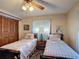Bedroom with matching twin beds, floral wallpaper, and natural light creates a cozy retreat at 724 Knob Hill Cir, Kissimmee, FL 34744