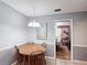 Cozy dining area with chandelier lighting, and a four-seat wooden dining table at 724 Knob Hill Cir, Kissimmee, FL 34744