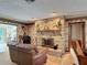 Warm Gathering room featuring a cozy brick fireplace and plush leather seating at 724 Knob Hill Cir, Kissimmee, FL 34744