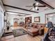 Comfortable living room with wood beams, hardwood floors, and leather furniture at 724 Knob Hill Cir, Kissimmee, FL 34744