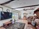 Inviting living room with hardwood floors, wood beams, and view of a pool at 724 Knob Hill Cir, Kissimmee, FL 34744