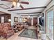 Spacious living room featuring wood floors, ceiling beams, and lots of natural light at 724 Knob Hill Cir, Kissimmee, FL 34744