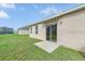 Expansive backyard with lush green grass and a sliding glass door at 724 Lake Cummings Blvd, Lake Alfred, FL 33850