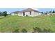 Large backyard with well-kept lawn, ideal for outdoor activities and relaxation at 724 Lake Cummings Blvd, Lake Alfred, FL 33850