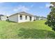 Spacious backyard with a lush green lawn, perfect for entertaining and Gathering gatherings at 724 Lake Cummings Blvd, Lake Alfred, FL 33850