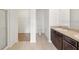 Spacious bathroom featuring dual sinks, granite countertop, dark wood vanity and large open shower at 724 Lake Cummings Blvd, Lake Alfred, FL 33850