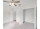 Comfortable bedroom with ceiling fan and carpet at 724 Lake Cummings Blvd, Lake Alfred, FL 33850