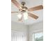 Bedroom ceiling fan with wooden blades and glass light fixture at 724 Lake Cummings Blvd, Lake Alfred, FL 33850