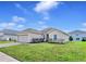 Charming single-story home with manicured lawn and beautiful landscaping at 724 Lake Cummings Blvd, Lake Alfred, FL 33850