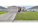 Charming single-story home with a well-manicured lawn and attached two-car garage at 724 Lake Cummings Blvd, Lake Alfred, FL 33850