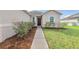 Inviting home exterior with a well-maintained front yard and walkway at 724 Lake Cummings Blvd, Lake Alfred, FL 33850